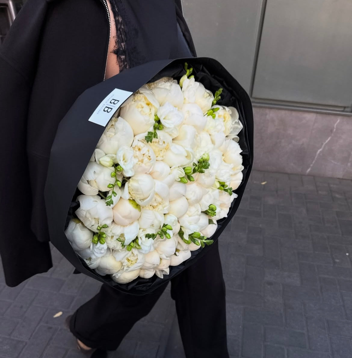 A bouquet of 50 white peonies
