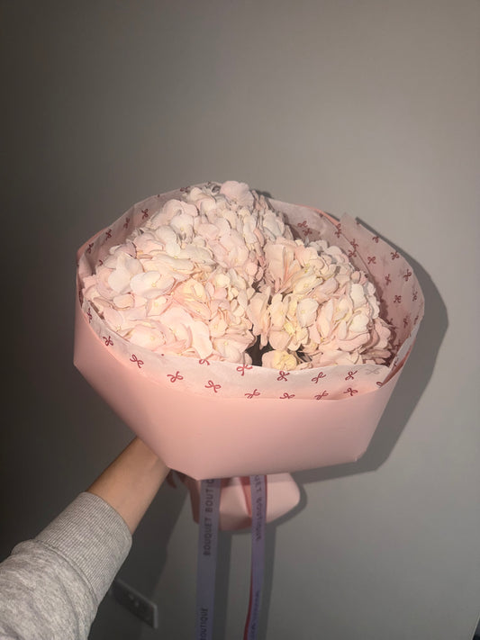 Cute bouquet of hydrangeas in pink package