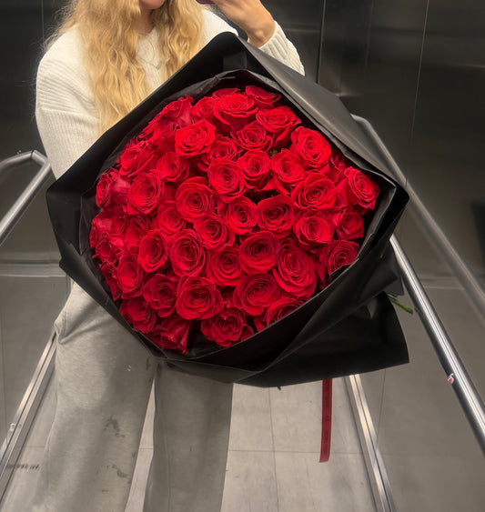 Bouquet of 50 red roses in black packaging