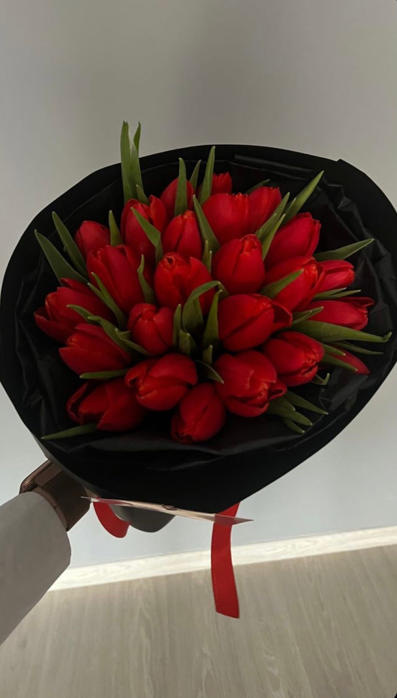 Bouquet of 25 red tulips in black packaging
