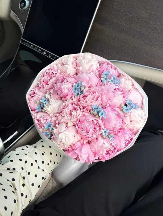 Fresh mixed floral bouquet with pink peonies and oxypetalum