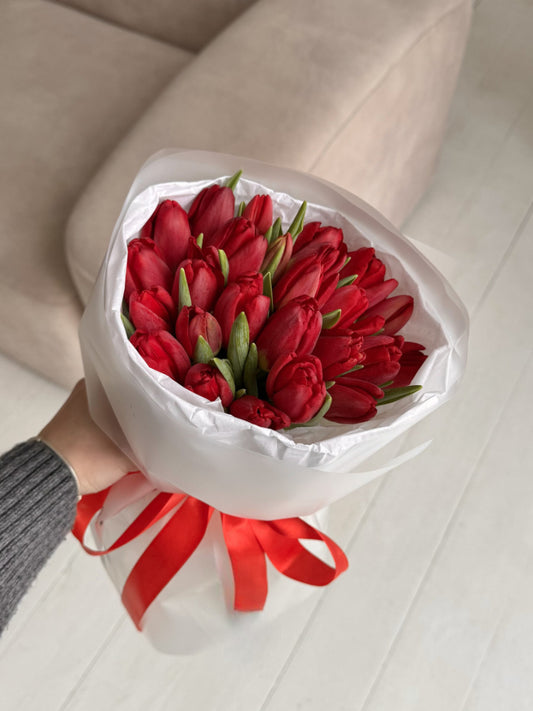 Bouquet of 25 red tulips in white packaging
