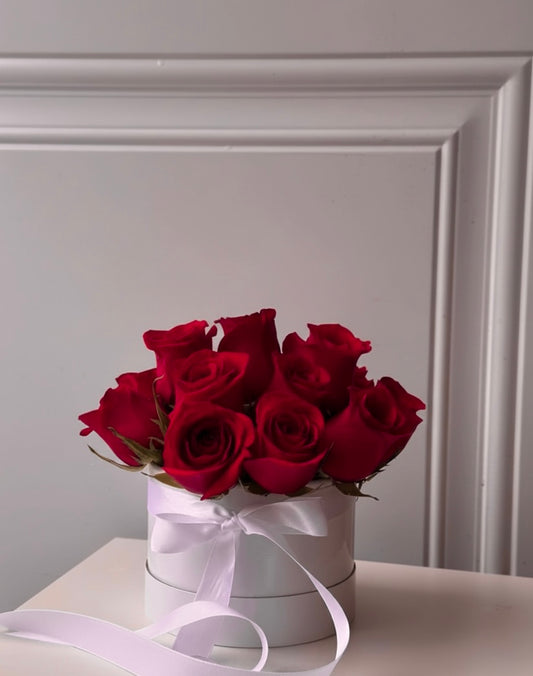 Raspberry-red roses in a white small box (raspberry hue)